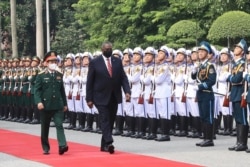 FILE - U.S. Secretary of Defense Lloyd Austin with Vietnamese Defense Minister Phan Van Giang, left, inspects an honor guard in Hanoi, Vietnam, July 29, 2021.