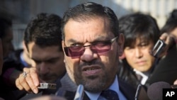Anas al-Abdeh, center, a member of the Syrian National Coalition, Syria's main political opposition group, is surrounded by journalists after a meeting with a delegation of the Syrian government at the United Nations headquarters in Geneva, Switzerland, 