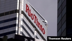 FILE - A sign adorns the building where mining company Rio Tinto has its office in Perth, Western Australia.