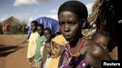 Karsi Tadicha and her children stand next to their house in Bule Duba village, on the outskirts of Moyale, Ethiopia, June 2009. (file photo)