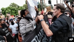 Protesters march past City Hall on June 2, 2020, in Philadelphia, over the death of George Floyd, who died after being restrained by Minneapolis police officers on May 25.