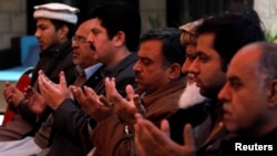 Relatives and family members of Naeem Rashid who was killed along with his son Talha Naeem in the Christchurch mosque attack in New Zealand, pray during a condolence gathering at the family's home in Abbottabad, Pakistan, March 17, 2019.