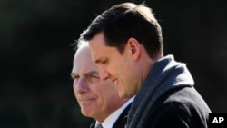 FILE - White House staff secretary Rob Porter, right, walks with White House Chief of Staff John Kelly to board Marine One on the South Lawn as they leave the White House in Washington, Feb. 2, 2018.