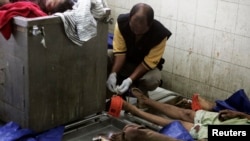 A forensic official tags the bodies of illegal migrants from Burma at a hospital in Medan in Indonesia's North Sumatra province, April 5, 2013.