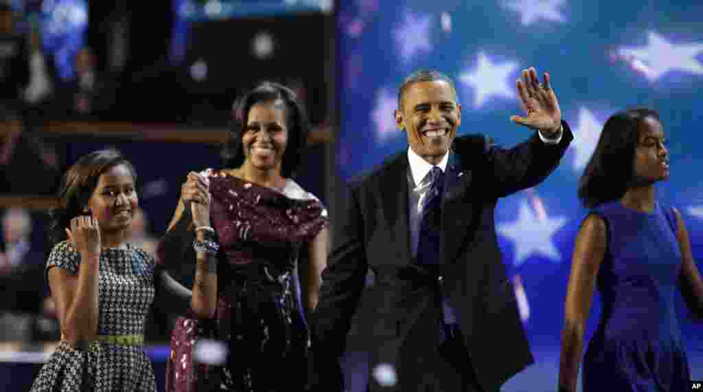 President Barack Obama and First lady Michelle Obama joined by their children Sasha, left, and Malia walks across the stage after President Obama&#39;s speech to the Democratic National Convention.