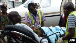 An injured Kenya Defense Force soldier is stretched into an ambulance to be transfered to the hospital after arriving in Nairobi, on Jan. 17, 2016, a day after an attack by the al-Qaeda-linked militants on an African Union base (AMISOM) in southwest Somalia.