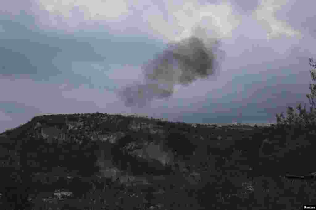 Smoke rises from what activists said were explosive barrels thrown by forces loyal to Syria's President Bashar al-Assad in Jabal al-Akrad, Latakia, Jan. 20, 2014.