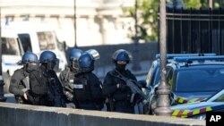 Security forces patrol outside at the Palace of Justice, Sept. 8, 2021 in Paris. France is putting on trial 20 men accused in the Islamic State group's 2015 attacks on Paris that left 130 people dead and hundreds injured.