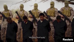 Militants from the so-called Islamic State stand behind what are said to be Ethiopian Christians in Libya, in this still image from an undated video posted to a social media website on April 19, 2015.
