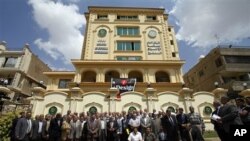 Egyptian Muslim Brotherhood Shura (Consultative) council members gather for a photo op outside the new Muslim Brotherhood headquarters in Cairo, April 30, 2011