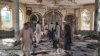Warga memeriksa kerusakan di dalam masjid di Kunduz, Afghanistan, setelah serangan bom berlangsung saat sholat Jumat (8/10).