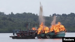 FILE - Malaysian and Vietnamese fishing boats are destroyed for illegal fishing by the Ministry of Maritime Affairs and Fisheries, police and navy, in Batam, Riau Islands, Indonesia, April 5, 2016. The Indonesian government reportedly sank 28 illegal fore