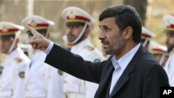 Iranian President Mahmoud Ahmadinejad gestures prior to an official welcoming ceremony for Qatari Emir Sheik Hamad Bin Khalifa Al Thani, unseen, in Tehran, Iran, 20 Dec 2010