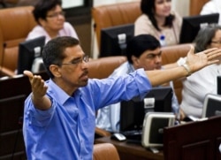FILE - Opposition legislator Victor Hugo Tinoco, of the Sandinista Renewal Movement, gestures in Managua, Nicaragua, Jan. 28, 2014.