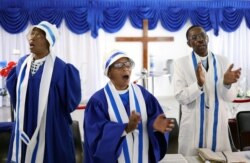 Faithful worship during a church service amid concerns about the spread of coronavirus disease (COVID-19) at the Apostolic Christian Church in Kagiso, west of Johannesburg, South Africa, March 22, 2020.