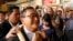 FILE - Sam Rainsy, foreground, leader of the opposition Cambodia National Rescue Party (CNRP), receives a garland of jasmine upon his arrival at Phnom Penh International Airport in Phnom Penh, Cambodia, Aug. 16, 2015.