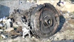 Security officers and Red Crescent workers are seen at the site where the Ukraine International Airlines plane crashed after takeoff from Iran's Imam Khomeini airport, on the outskirts of Tehran, Iran, Jan. 8, 2020.