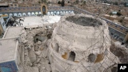Iraqis gather at the ruins of the al-Askari mosque in Samarra, Iraq (File Photo)