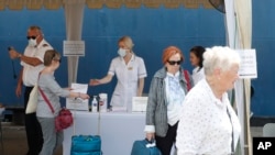 Passengers undergo temperature check as a part of precautionary measures to prevent the spread of new Corona virus before they board a cruise at the Colombo Port in Colombo, Sri Lanka, Thursday, Feb. 6, 2020. As on Thursday, a viral outbreak that…