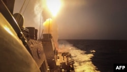 FILE - This handout picture courtesy of the US Navy taken on Oct. 19, 2023 shows the Arleigh Burke-class guided-missile destroyer USS Carney (DDG 64) defeating a combination of Houthi missiles and unmanned aerial vehicles in the Red Sea.