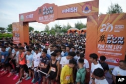 Participants prepare for the start of a 5km running event titled 'Run for Life, Tsunami Memorial 2024' held to commemorate the 20th anniversary of the Indian Ocean tsunami, in Banda Aceh, Aceh province, Indonesia, Dec. 15, 2024.