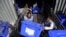 Afghan election workers load ballot boxes and other election materials on a truck for distribution at the Independent Election Commission compound, in Kabul, Afghanistan, Sept. 23, 2019. The election is Saturday.