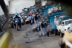 FILE - People ride motorcycles in Douala, Cameroon, Nov. 4, 2013.