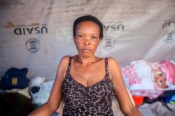 Vesta Guerrier, 48, poses for a portrait at a camp for people who lost their homes during the Aug. 14 earthquake, in Les Cayes, Haiti, Aug. 23, 2021.