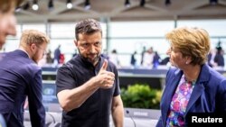 Ukrainian President Volodymyr Zelenskyy reacts next to Swiss President Viola Amherd during the Ukraine Peace Summit in Stansstad, Switzerland, June 16, 2024.
