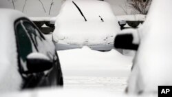 Cars are covered by snow, following a winter storm, Jan. 28, 2019, in Wheeling, Illinois, as the entire region braces itself for record-low subzero temperatures. 