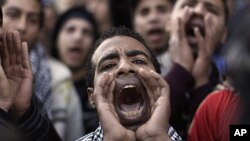 An Egyptian student shouts anti-military slogans during a protest as part of a general strike in Cairo University, February 11, 2012.