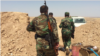 Kurdish Peshmerga soldiers at a bunker at the Kurdistan frontline, northern Iraq, east of Mosul. (S. Behn/VOA)