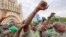 Colonel Malick Diaw, center, vice-president of the CNSP (National Committee for the Salvation of the People), gestures to supporters as Malian soldiers escort him through the Independence Square in Bamako, Aug. 21, 2020. 