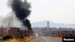 Smoke rises from Taybat al Imam town after rebel fighters from the hardline jihadist Jund al-Aqsa advanced in the town in Hama province, Syria August 31, 2016. 