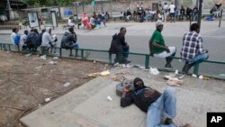 Migrants are seen gathered near a reception center for migrants in Paris, France, July 10, 2017. 