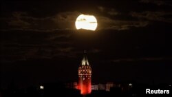 The supermoon is seen over the historical Galata Tower in Istanbul, Turkey, early November 14, 2016. 