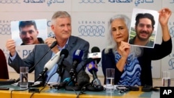 Marc and Debra Tice, the parents of Austin Tice, who has been missing in Syria since August 2012, hold up photos of him during a new conference, at the Press Club, in Beirut, Lebanon, July 20, 2017. 