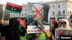 Libyan protesters attend a demonstration to demand an end to the Khalifa Haftar's offensive against Tripoli, in Martyrs' Square in central Tripoli, Libya, April 19, 2019.