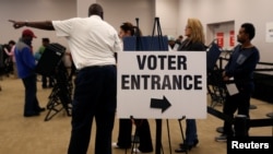 FILE - Voters wait in line to cast their ballots during early voting at the Franklin County Board of Elections in Columbus, Ohio, Oct. 28, 2016