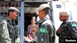 Brazilian soldiers conduct an inspection for the Aedes aegypti mosquito as part of efforts to prevent the spread of the Zika virus, along a street in Sao Paulo, Brazil, Feb. 1, 2016. 