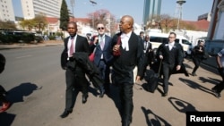 Lawyers representing opposition Movement for Democratic Change (MDC) leader Nelson Chamisa arrive at court to challenge President Emmerson Mnangagwa's election victory in Harare, Aug. 22, 2018. 