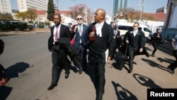 Lawyers representing opposition Movement for Democratic Change (MDC) leader Nelson Chamisa arrive at court to challenge President Emmerson Mnangagwa's election victory, in Harare, Zimbabwe, Aug. 22, 2018. 
