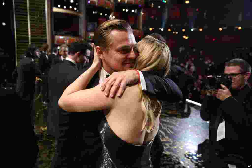 Leonardo DiCaprio, winner of the award for best actor in a leading role for "The Revenant", left, embraces Kate Winslet backstage at the Oscars on Feb. 28, 2016, at the Dolby Theatre in Los Angeles. 