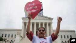Antonio Surco of Silver Spring, Md. participates in a demonstration outside the Supreme Court in Washington, June 23, 2016. 