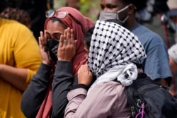 A woman reacts to news in the Breonna Taylor shooting, Sept. 23, 2020, in Louisville, Ky. A grand jury has indicted one officer on criminal charges six months after Taylor was fatally shot by police in Kentucky.