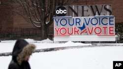 A person walks on the Saint Anselm College campus, ahead of a Democratic party debate in Manchester, N.H., Feb. 7, 2020.
