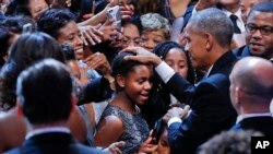 President Barack Obama pats two young girls on the head as he greets guests after speaking at the Congressional Black Caucus Foundation's annual Legislative Conference Phoenix Awards Dinner, Saturday, Sept. 17, 2016, in Washington.