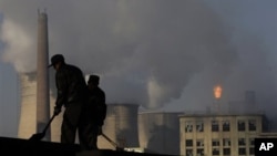 Cooling towers of a power plant and chemical factory in China. Among the 1,200 proposed coal-fired power plants 76 percent will be built in China and India, already among the top emitters of climate changing greenhouse gases. 