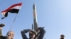 A Houthi follower carries a mock rocket in Sanaa on January 29, 2024, to show support for Houthi strikes on ships in the Red Sea and the Gulf of Aden, as well as solidarity with the Palestinians. (Khaled Abdullah/Reuters)