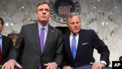 FILE - Senate Intelligence Committee Vice Chairman Mark Warner, D-Va., left, and Sen. Richard Burr, R-N.C., the panel chairman, are pictured prior to a hearing on Capitol Hill in Washington, May 9, 2018.
